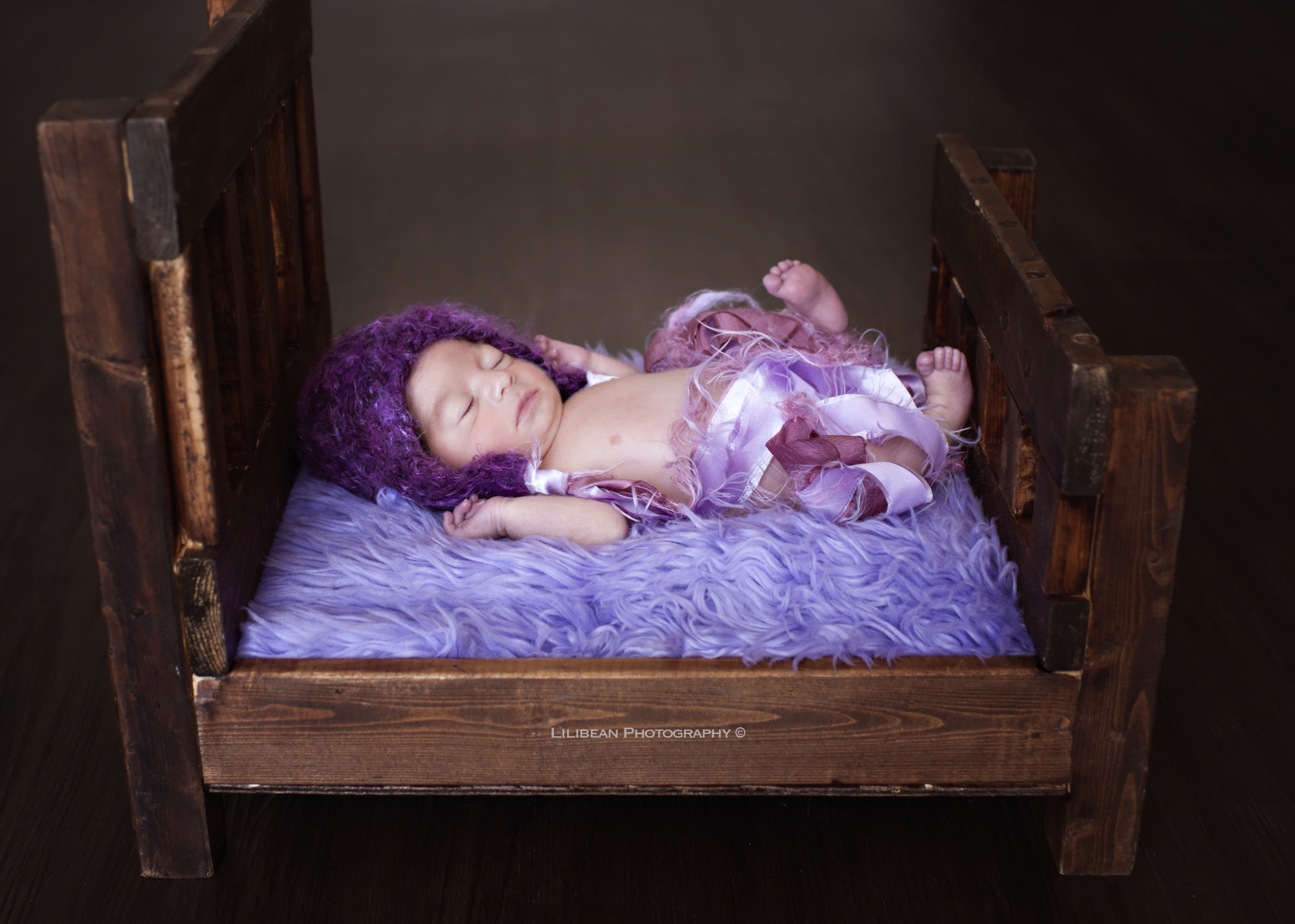southfloridanewbornphotographer purple lavendar miami photographer baby bed wood bed