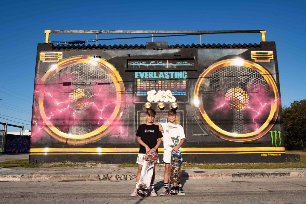 Twin boys in front of radio mural in wynwood in miami